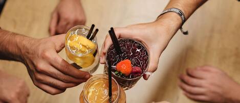 A group of people holding drinks in a circle.