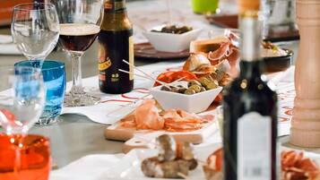 Uma mesa posta com diversos alimentos, copos e garrafas.