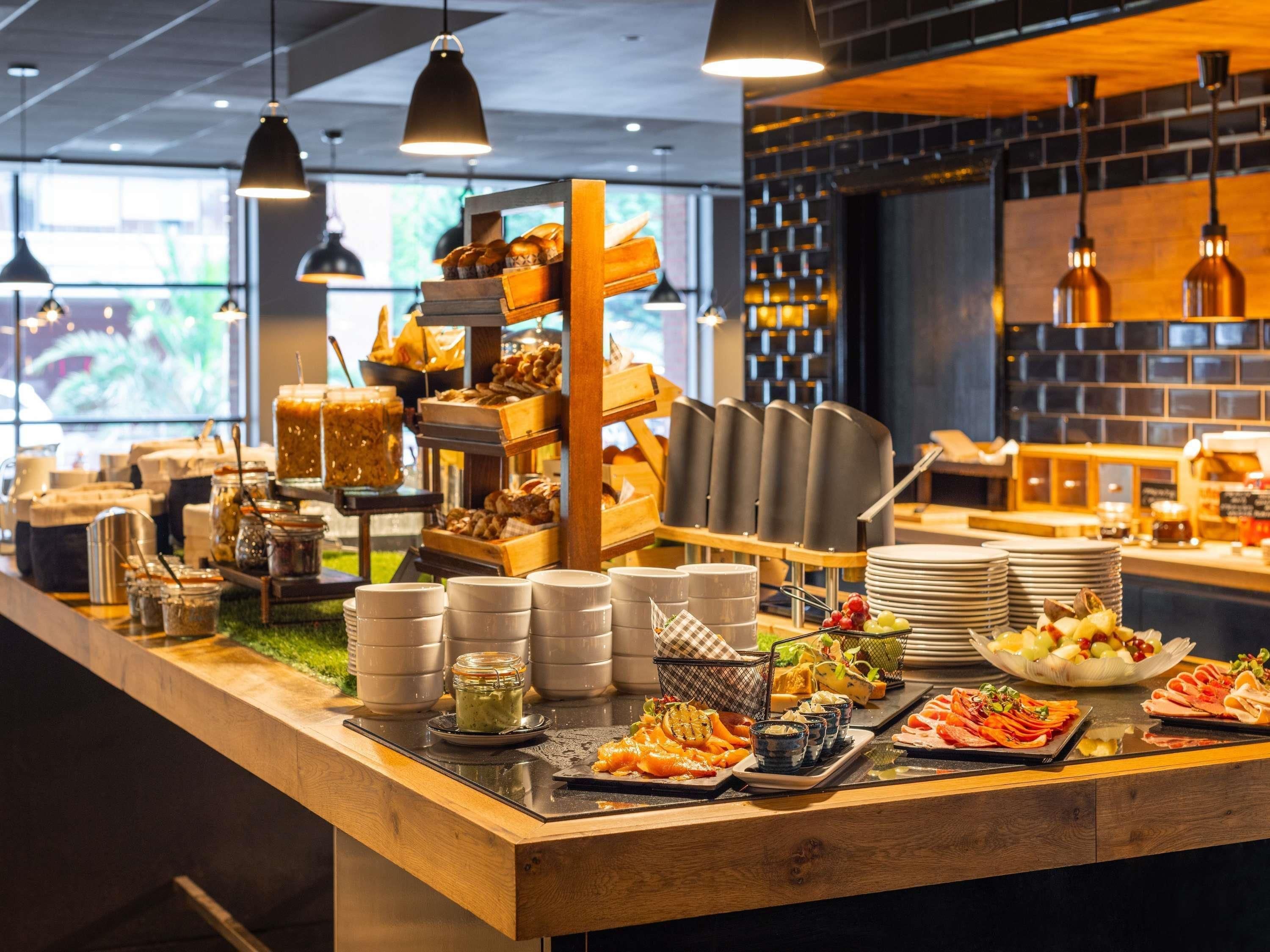 A buffet setup with various food items and condiments.