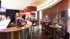 A modern bar area with a curved counter, seating, and a TV screen. - Novotel Leuven Centrum (Leuven)