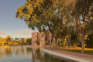 A building with arched windows and a reflective pool.