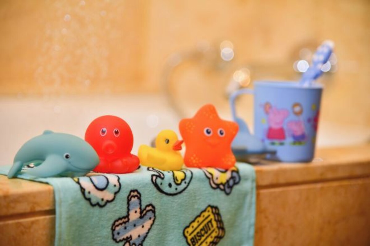 A table with plush toys and a mug on a countertop.