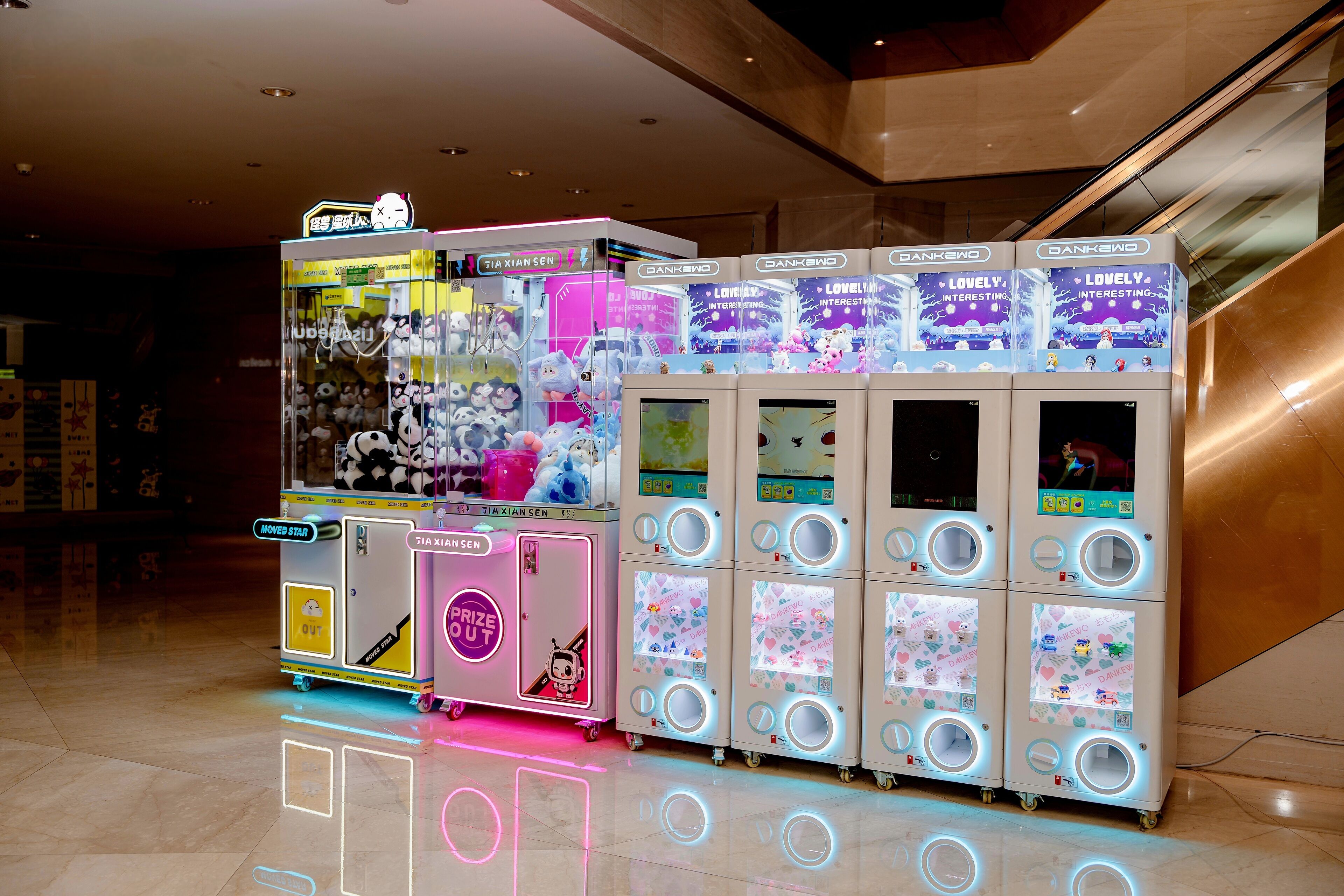 A row of claw machines in a mall.