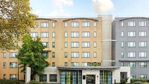 A B&B hotel with a modern design, featuring a central entrance with glass doors, multiple floors, and a flat roof. - B&B HOTEL Paris Grand Roissy CDG Aéroport (Roissy-en-France)