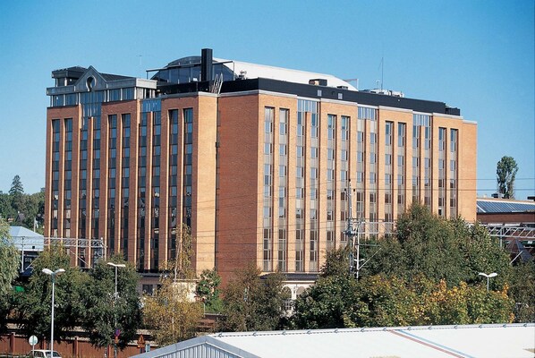 A multi-story building with a brick facade and large windows.