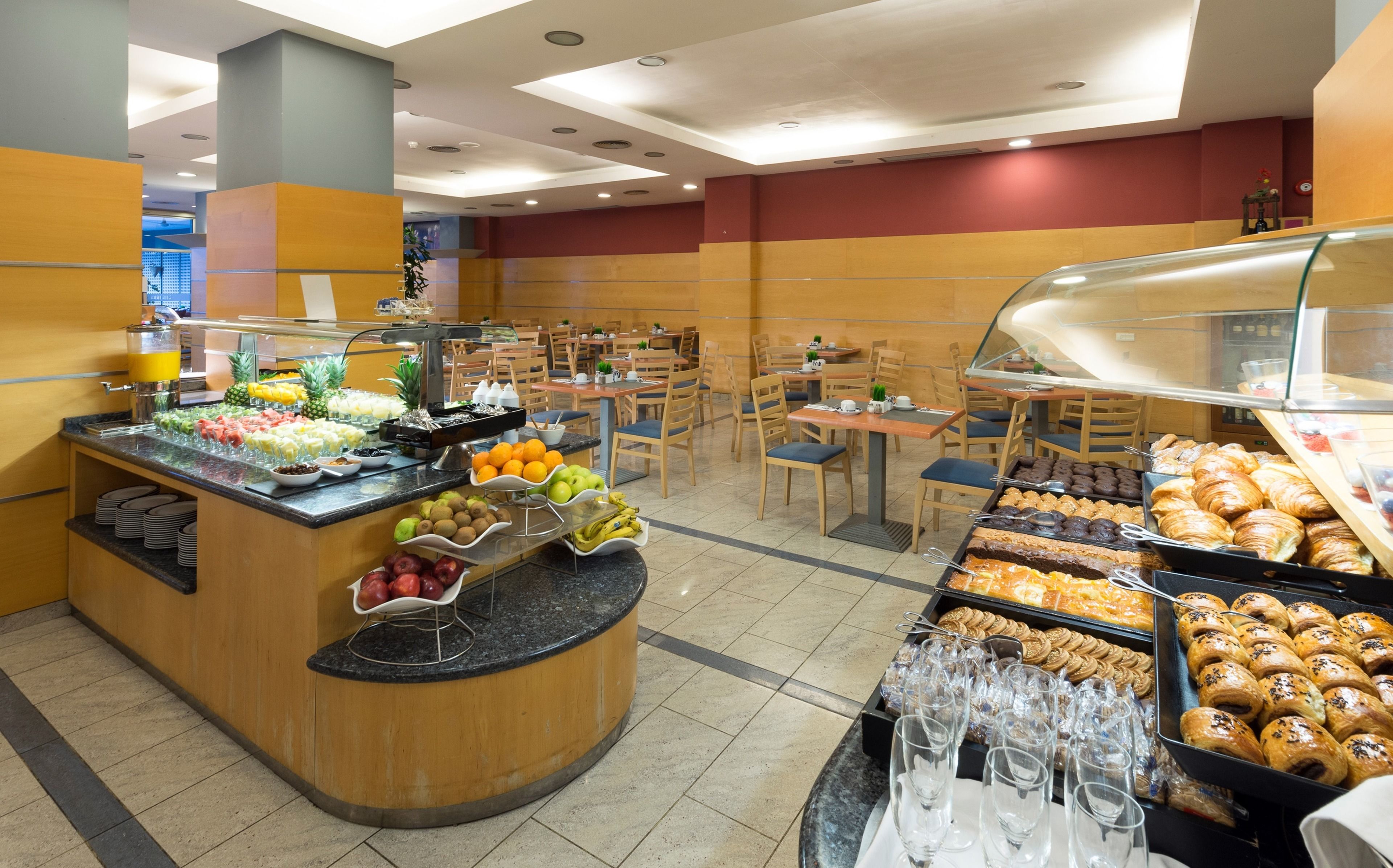 A buffet area with various food options and seating arrangements.