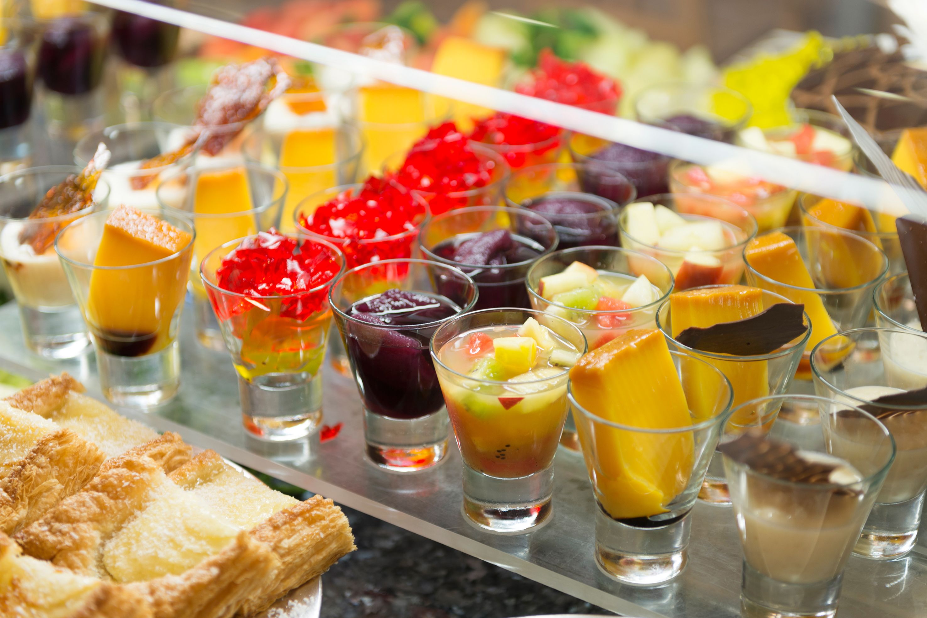 A variety of desserts and beverages on a tray.