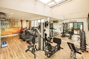 A gym with treadmills, weight machines, and free weights.
