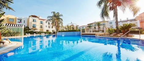 Seasonal outdoor pool, pool umbrellas, pool loungers