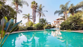 Seasonal outdoor pool, pool umbrellas, pool loungers