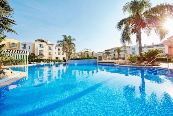 Seasonal outdoor pool, pool umbrellas, pool loungers