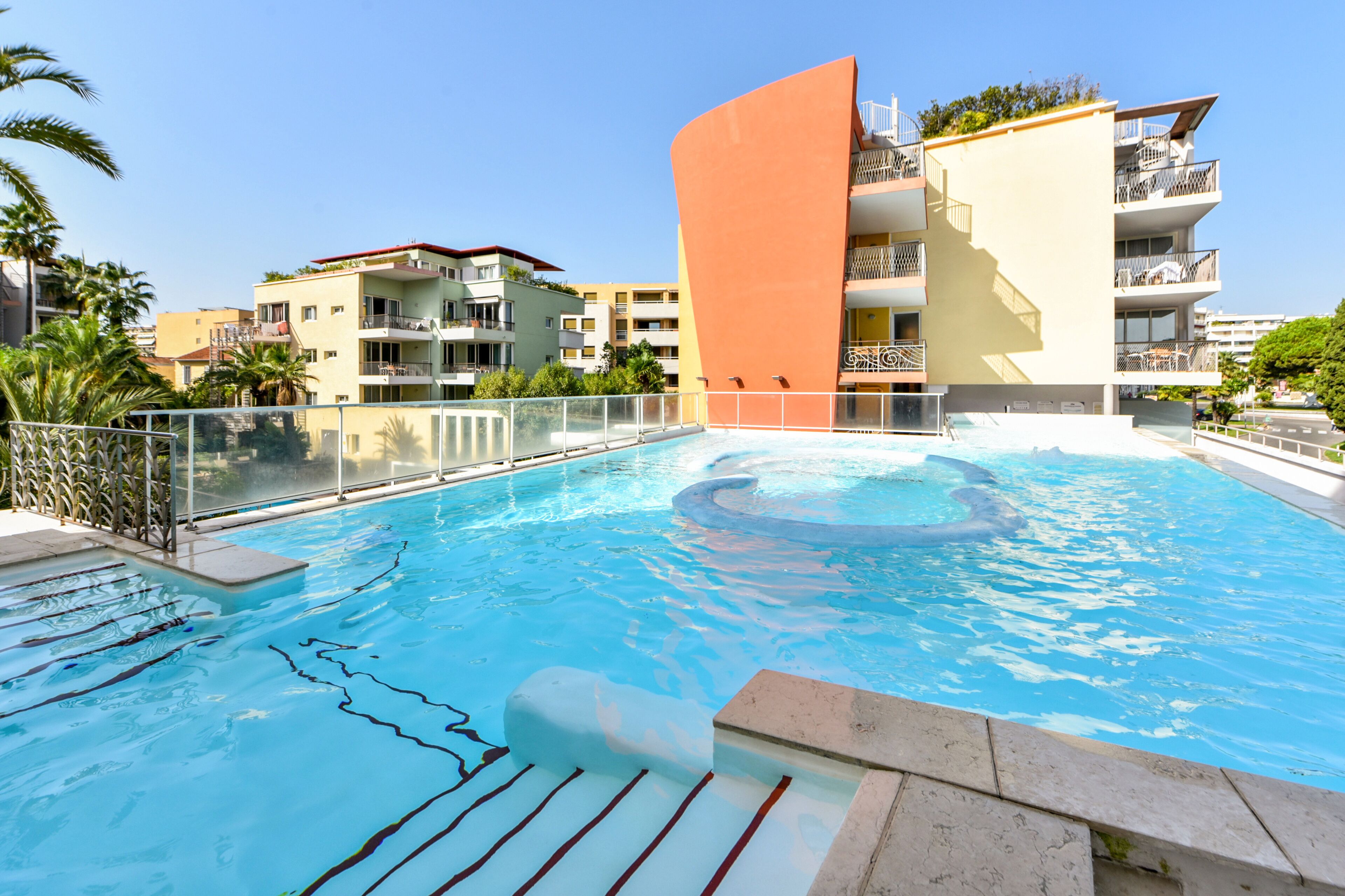 A swimming pool with a modern building in the background.