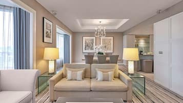 A modern hotel room with a sofa, two lamps, a dining table, and artwork on the walls.