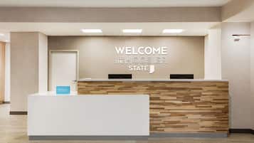 A reception desk with a "WELCOME THE HOOSIER STATE" sign above it.