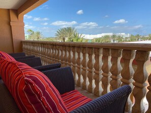 Relax on the balcony with comfortable seating for four, featuring two sofas and two armchairs.