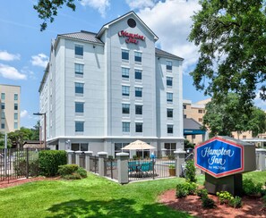 A Hampton Inn by Hilton building with a pool area in front. - Hampton Inn Biloxi (Biloxi)