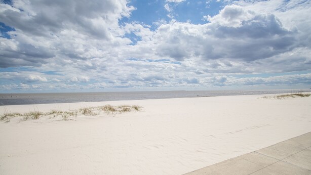 A wide sandy beach with a clear sky and clouds. - Hampton Inn Biloxi (Biloxi)