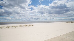A wide sandy beach with a clear sky and clouds. - Hampton Inn Biloxi (Biloxi)