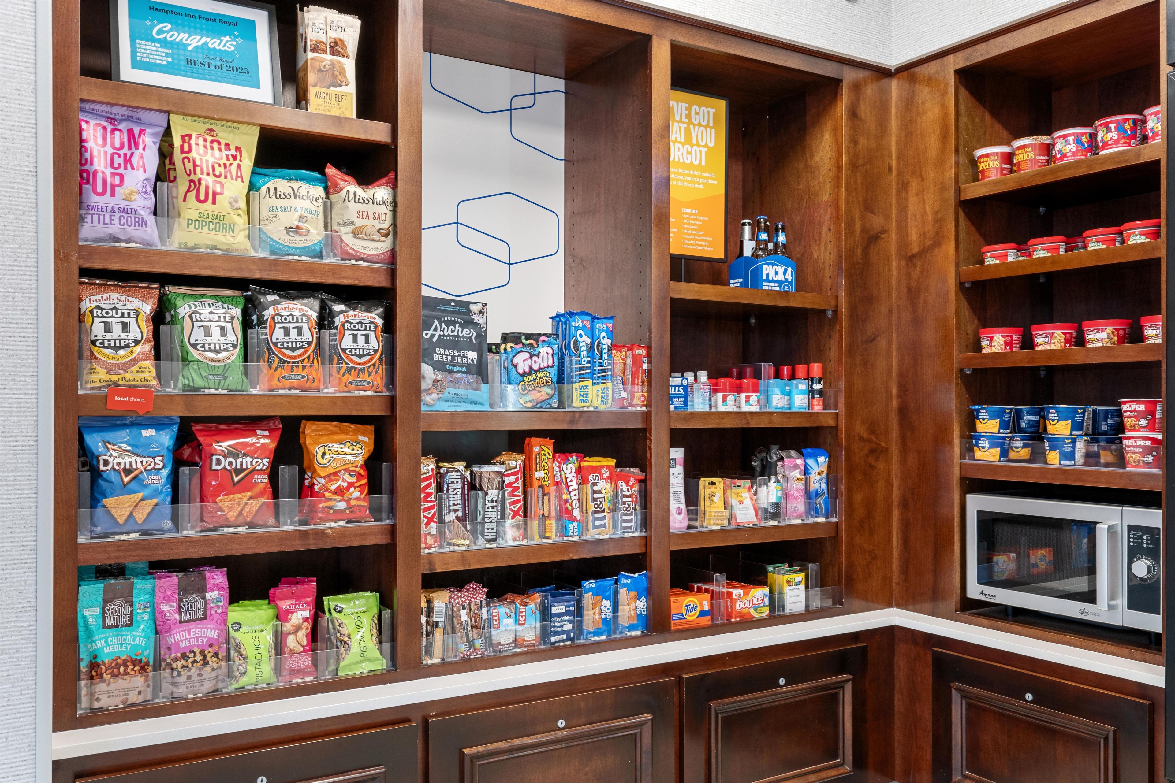 A well-organized pantry with various food items and kitchen appliances.