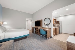 A hotel room with a bed, desk, chair, TV, and kitchenette. - Hampton Inn Front Royal (Front Royal)
