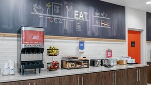 A kitchen area with a juice station, a bakery sign, and a kitchen sign.