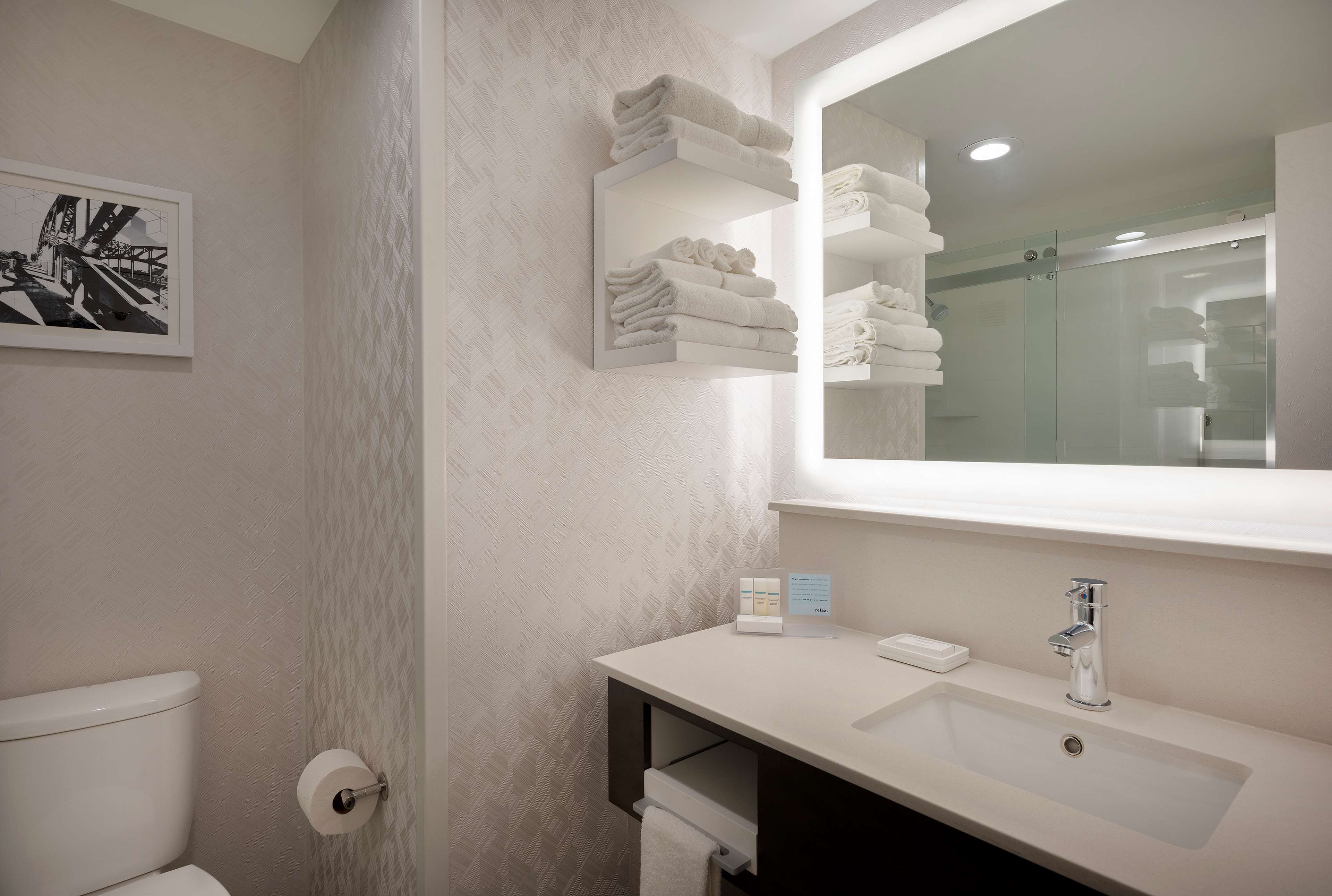 designer toiletries, hair dryer, towels, soap