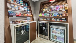 A snack and beverage display area with refrigerated sections and shelves stocked with various snacks and drinks. - Hampton Inn Elkton (Elkton)