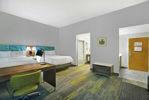 A hotel room with two beds, a desk, a chair, and a bathroom visible through an open door. - Hampton Inn & Suites Augusta West (Augusta)