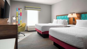 A hotel room with two beds, a desk, a chair, a TV, and a window with a view. - Hampton Inn Chicopee/Springfield (Chicopee)