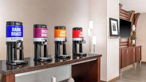 A coffee station with four dispensers labeled 'Dark Roast,' 'Decaf Roast,' 'Light Roast,' and 'Hot Water.' - Hampton Inn & Suites Sacramento-Cal Expo (Sacramento)