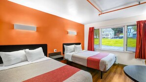 A hotel room with two beds, a window with a view of the outside, and a wooden floor. - Motel 6 Ilion, NY (Ilion)