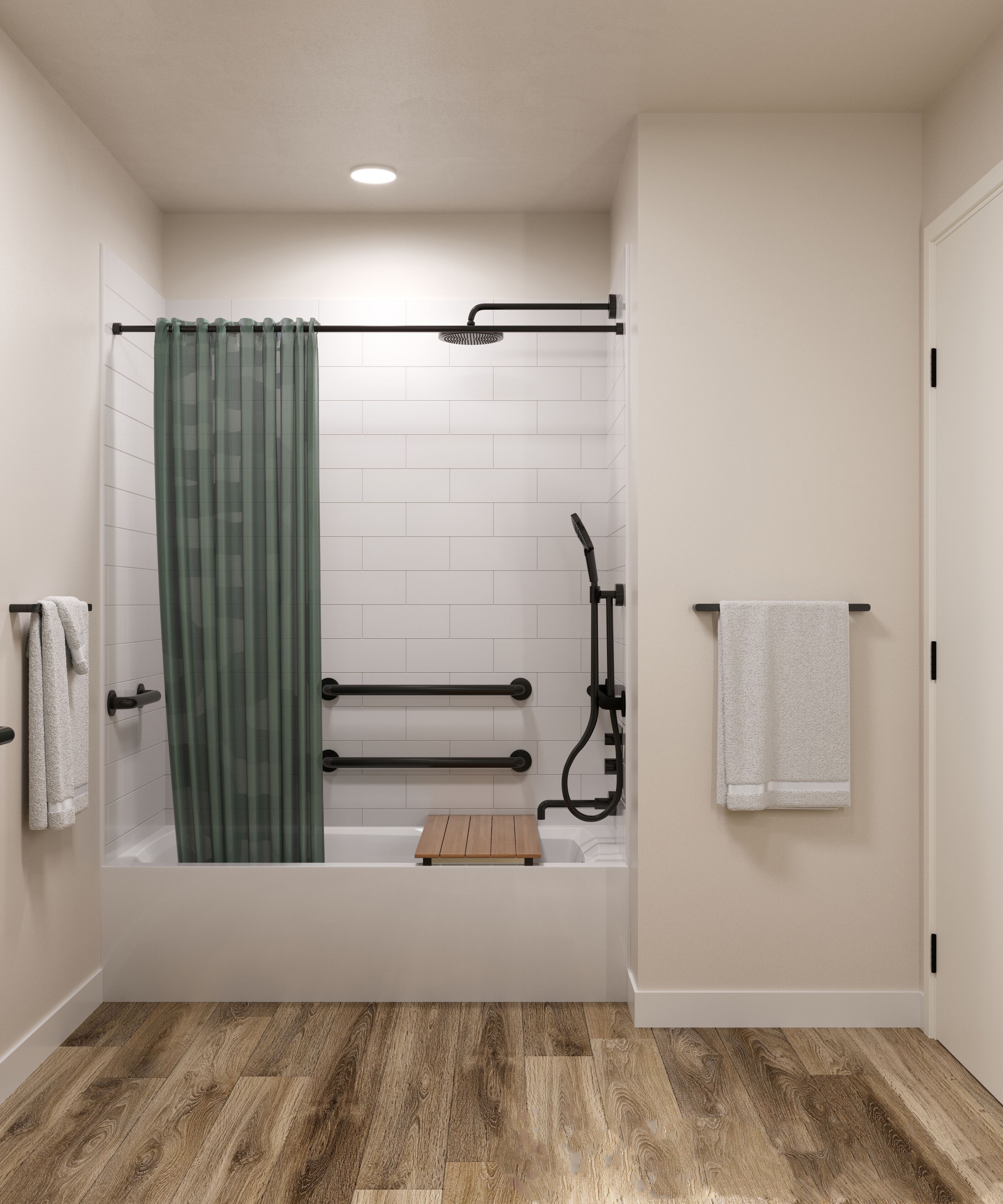 A modern bathroom with a bathtub, shower, and wooden flooring.