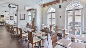 A spacious dining area with high ceilings, large windows, and a classic architectural design. - Village Hotel Albert Court by Far East Hospitality (Singapore)