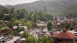 A town with a prominent tower, a parking lot, and various buildings. - Gatlinburg Chateau Rentals (Gatlinburg)
