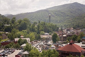 A town with a prominent tower, a parking lot, and various buildings. - Gatlinburg Chateau Rentals (Gatlinburg)