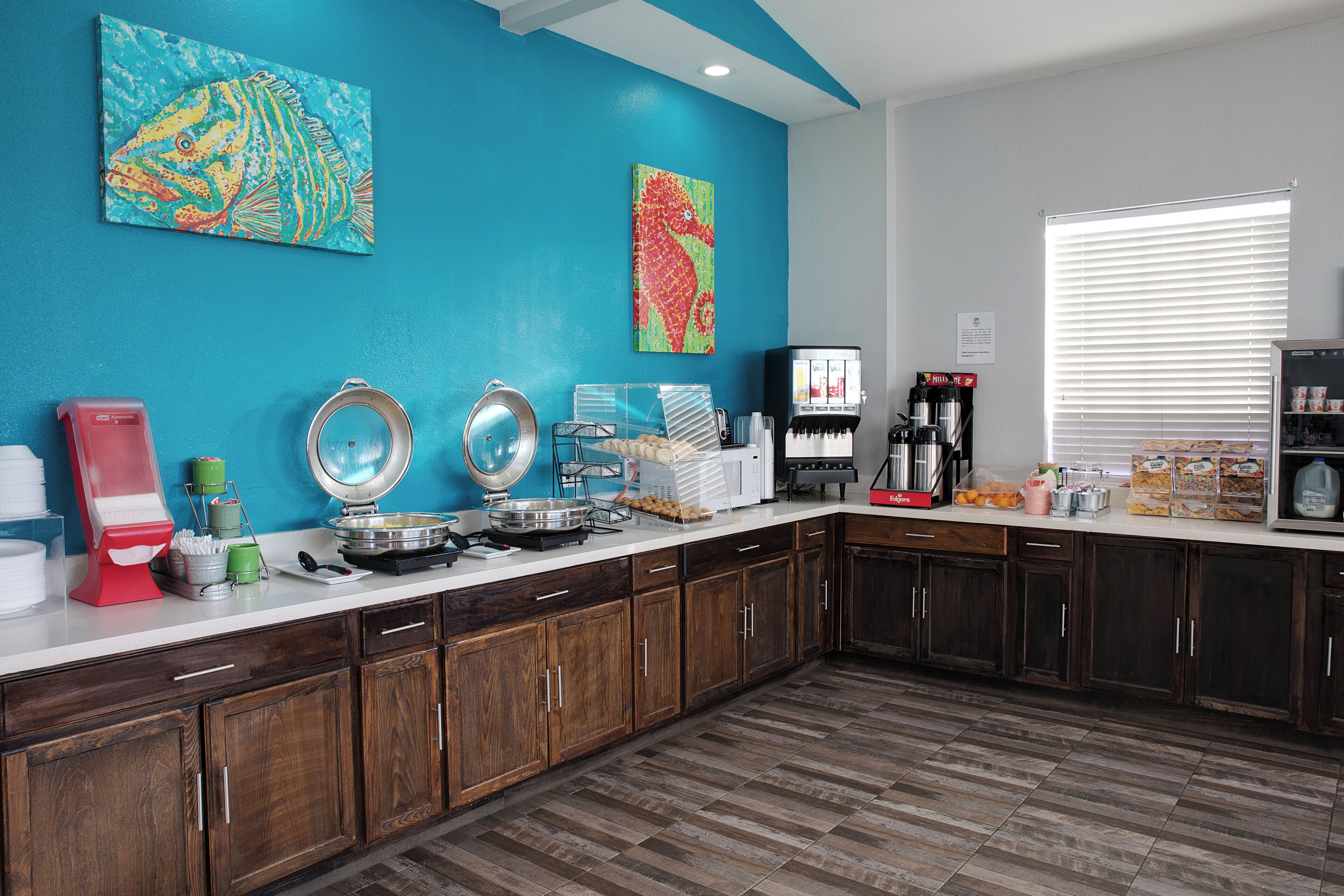 A kitchen with wooden cabinets, a white countertop, and various kitchen appliances.