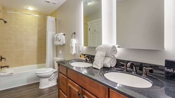 Suite, 1 King Bed with Sofa bed, Non Smoking | Bathroom | Combined shower/bathtub, free toiletries, hair dryer, towels
