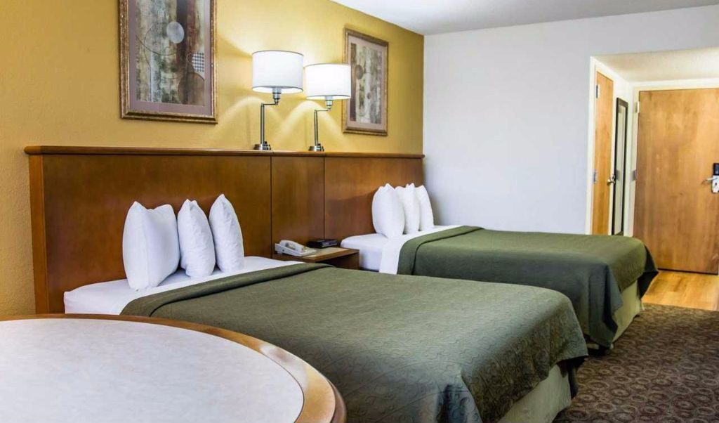 Premium bedding, desk, laptop workspace, blackout drapes
