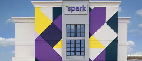 A building with the name 'spark' on the facade, featuring a geometric pattern of triangles and rectangles.