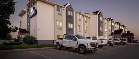A Days Inn hotel with a parking lot, a white pickup truck, and a row of similar buildings.
