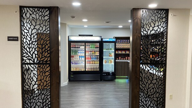 A corridor with two vending machines and a 'MARKET PLACE' sign. - Sleep Inn St. Robert-Fort Leonard Wood (St. Robert)