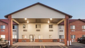 A two-story motel with a covered entrance, a parking lot, and a brick facade. - Super 8 by Wyndham Monmouth IL (Monmouth)