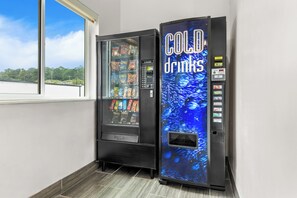 A vending machine with a 'COLD drinks' sign and a window display.