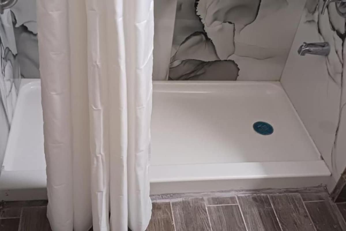 A bathroom with a shower, a bathtub, and a toilet.