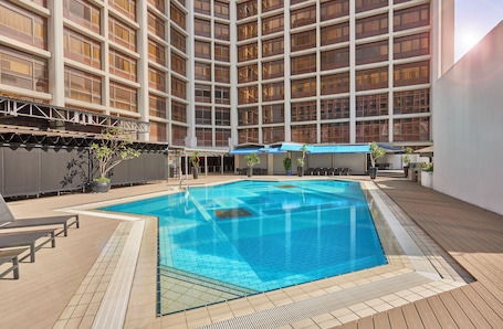 Outdoor pool, open 7:00 AM to 8:00 PM, pool umbrellas, pool loungers. Village Hotel Bugis by Far East Hospitality