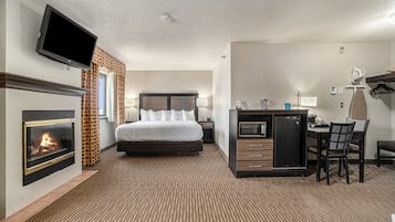 Suite, 1 King Bed, Jetted Tub (with fireplace and Sofa) | Desk, blackout curtains, iron/ironing board, rollaway beds