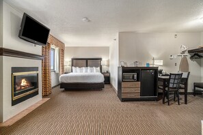 Relax in this stylish room with a large bed, flat-screen TV, and desk with a refrigerator.
