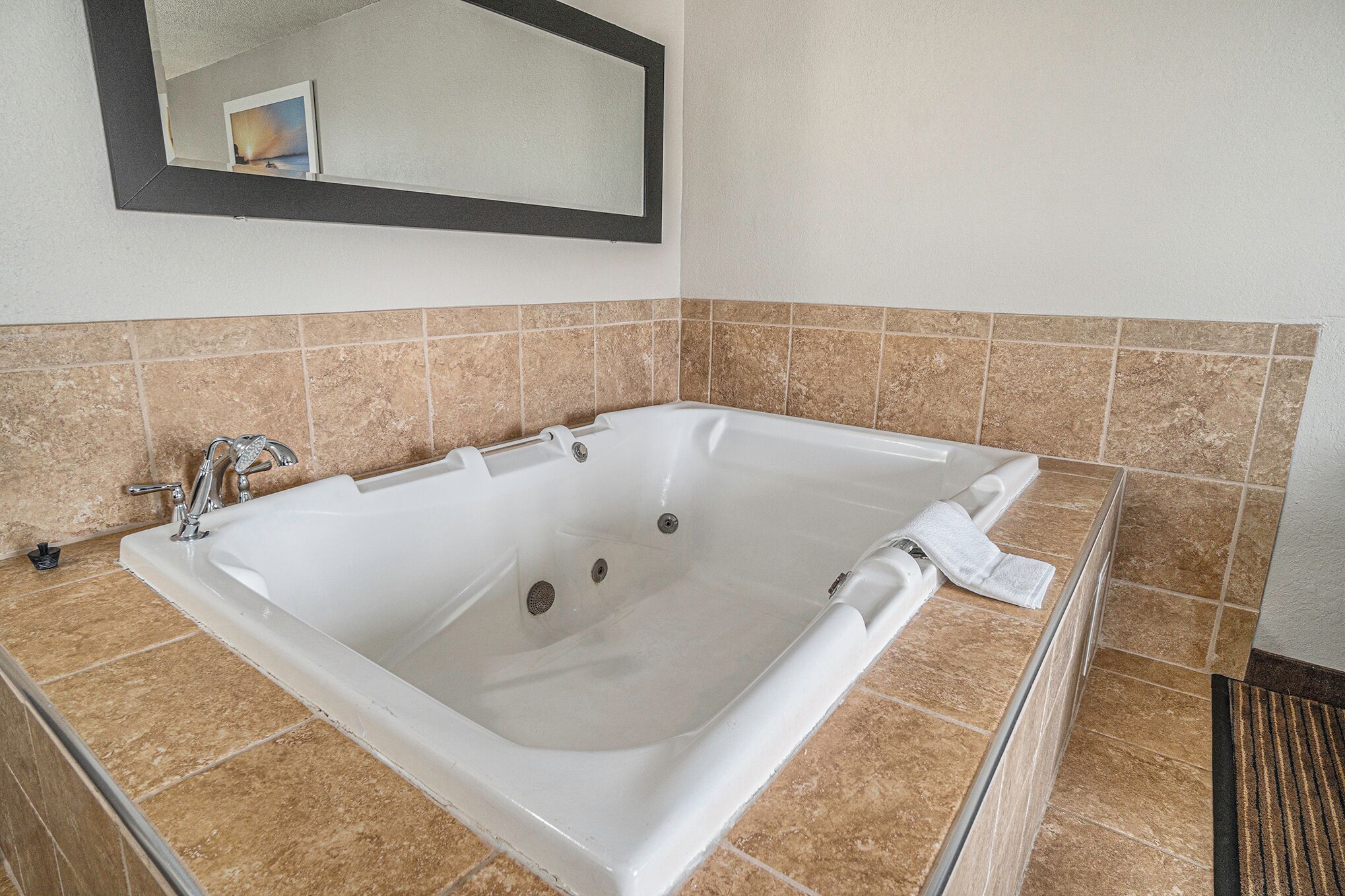 suite, 1 king bed, jetted tub (with fireplace and sofa) | desk, blackout curtains, iron/ironing board, rollaway beds