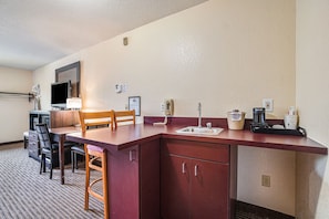 Enjoy a home away from home with a kitchenette, dining table, and comfortable seating for four.