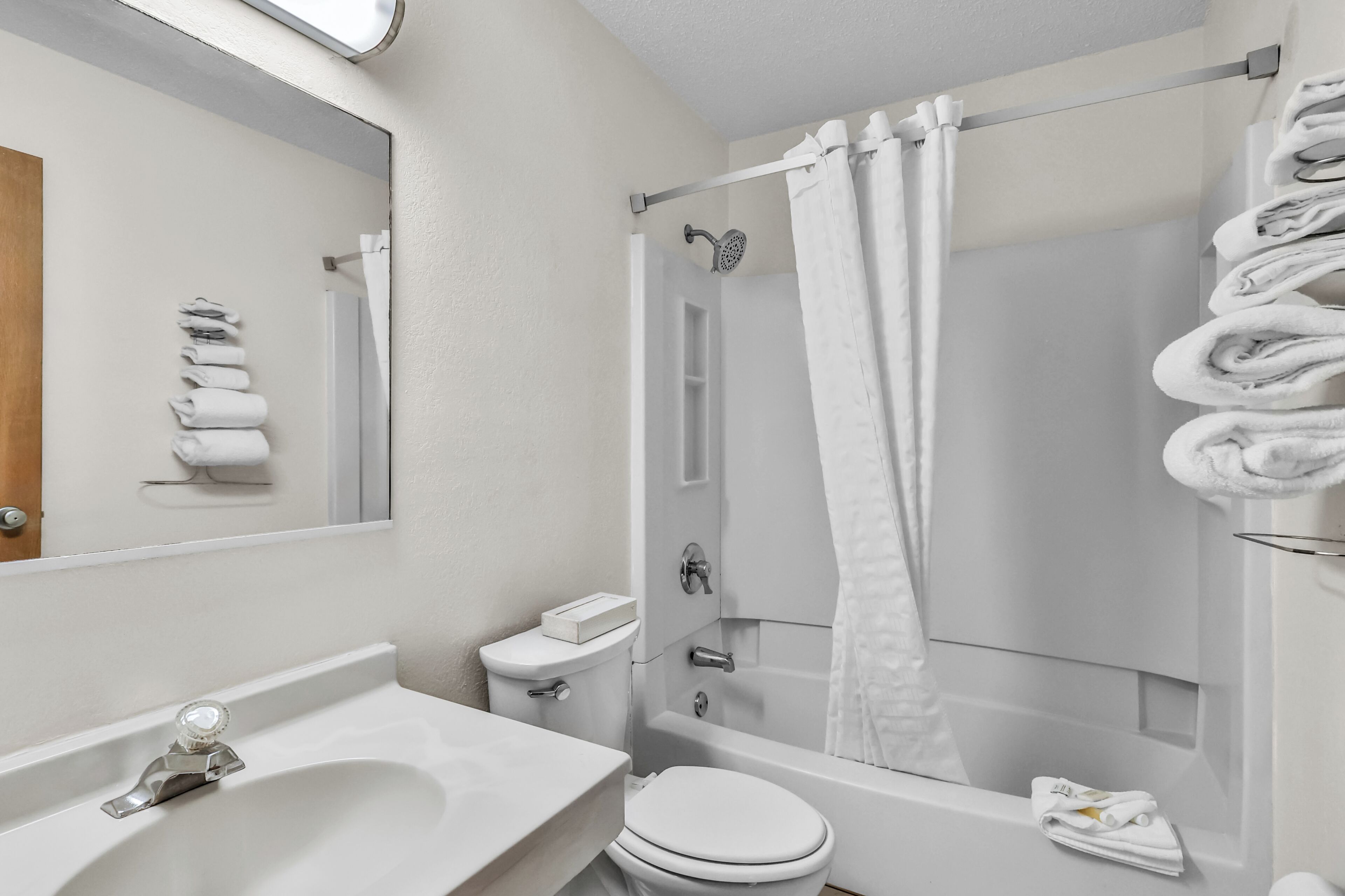 A bathroom with a sink, toilet, and bathtub.